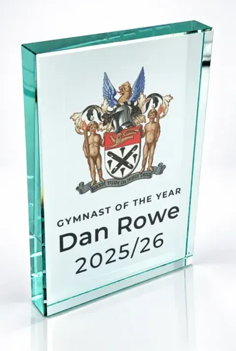 Large portrait glass award printed with a club crest and the wording Gymnast Of The Year, Dan Rowe, 2025/26