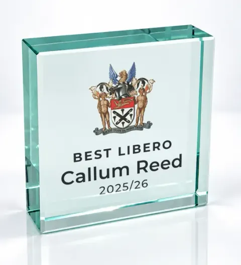 Small square glass award printed with a club crest and the wording Best Libero, Callum Reed, 2025/26