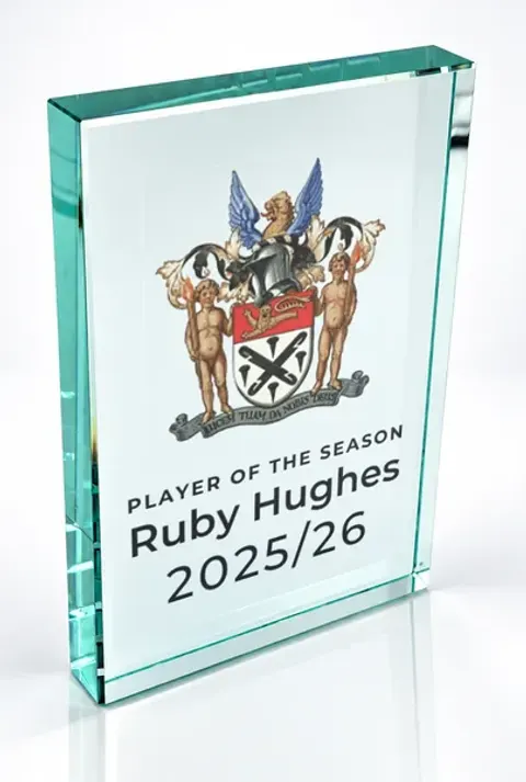 Large portrait glass award printed with a club crest and the wording Player Of The Season, Ruby Hughes, 2025/26