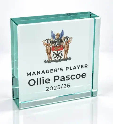 Small square glass award printed with a club crest and the wording Manager'S Player, Ollie Pascoe, 2025/26