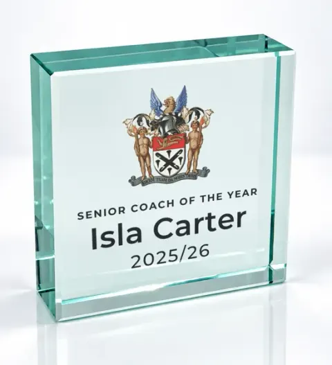 Small square glass award printed with a club crest and the wording Senior Coach Of The Year, Isla Carter, 2025/26
