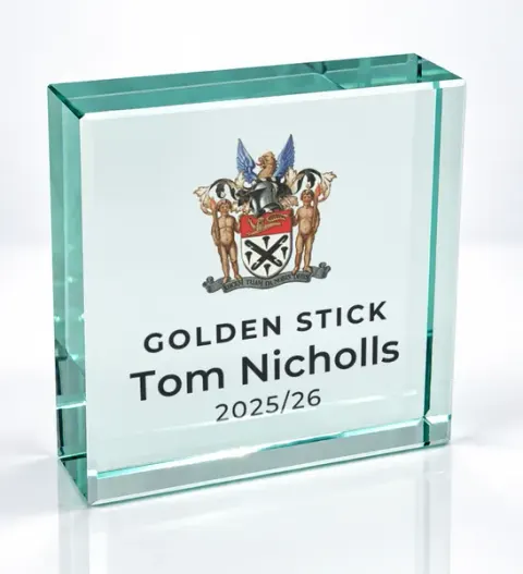 Small square glass award printed with a club crest and the wording Golden Stick, Tom Nicholls, 2025/26