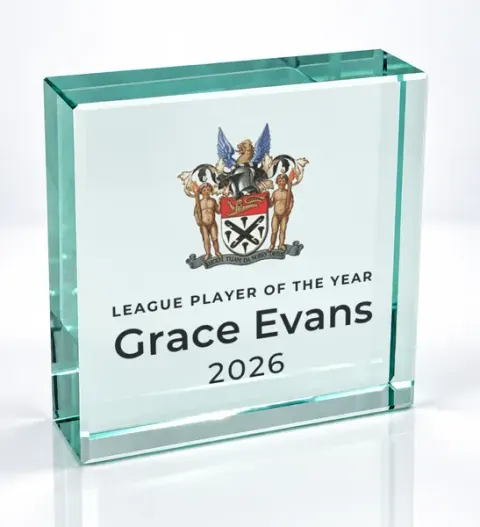Small square glass award printed with a club crest and the wording League Player Of The Year, Grace Evans, 2026