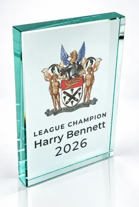Large portrait glass award printed with a club crest and the wording League Champion, Harry Bennett, 2026