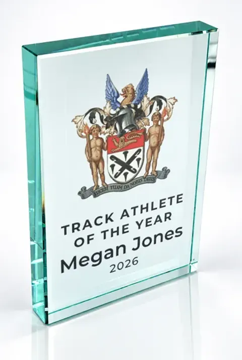 Large portrait glass award printed with a club crest and the wording Track Athlete Of The Year, Megan Jones, 2026