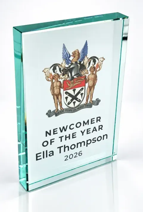Large portrait glass award printed with a club crest and the wording Newcomer Of The Year, Ella Thompson, 2026