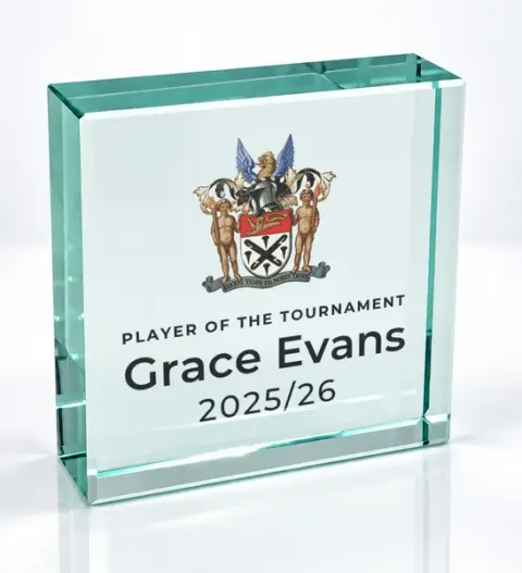 Small square glass award printed with a club crest and the wording Player Of The Tournament, Grace Evans, 2025/26