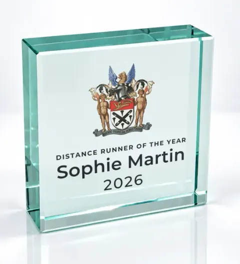 Small square glass award printed with a club crest and the wording Distance Runner Of The Year, Sophie Martin, 2026