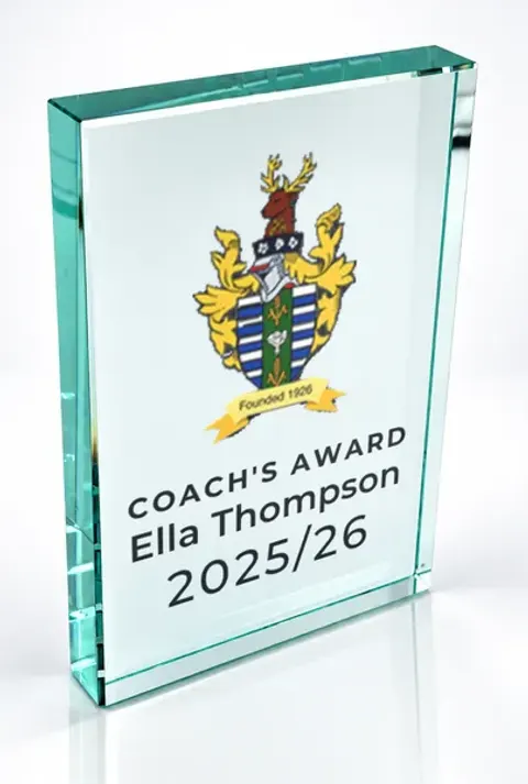 Large portrait glass award printed with a club crest and the wording Coach'S Award, Ella Thompson, 2025/26