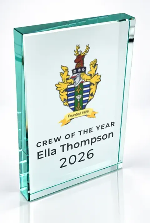 Large portrait glass award printed with a club crest and the wording Crew Of The Year, Ella Thompson, 2026