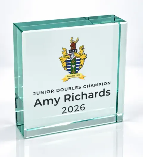 Small square glass award printed with a club crest and the wording Junior Doubles Champion, Amy Richards, 2026