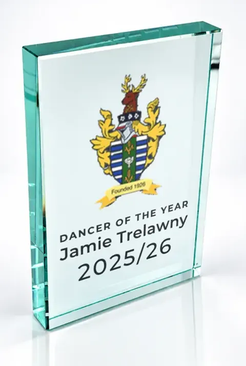 Large portrait glass award printed with a club crest and the wording Dancer Of The Year, Jamie Trelawny, 2025/26