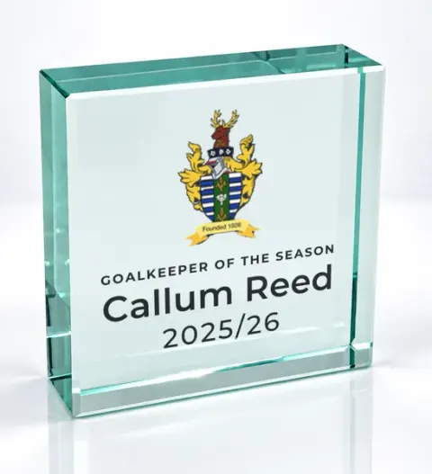Small square glass award printed with a club crest and the wording Goalkeeper Of The Season, Callum Reed, 2025/26