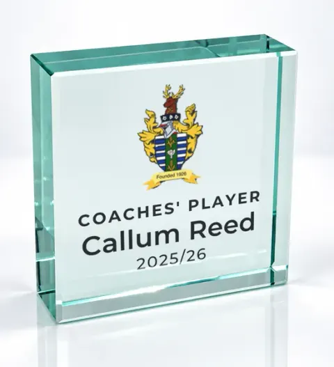 Small square glass award printed with a club crest and the wording Coaches' Player, Callum Reed, 2025/26