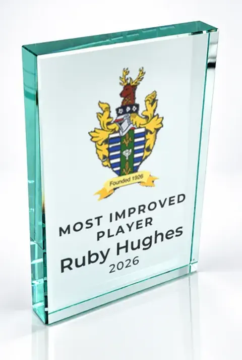 Large portrait glass award printed with a club crest and the wording Most Improved Player, Ruby Hughes, 2026