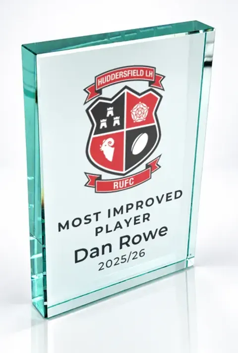 Large portrait glass award printed with a club crest and the wording Most Improved Player, Dan Rowe, 2025/26