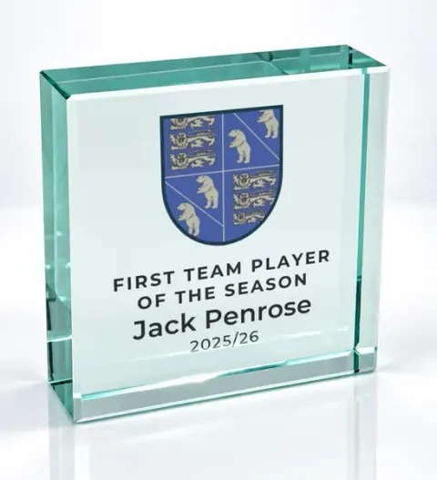 Small square glass award printed with a club crest and the wording First Team Player Of The Season, Jack Penrose, 2025/26