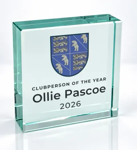 Small square glass award printed with a club crest and the wording Clubperson Of The Year, Ollie Pascoe, 2026