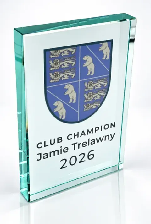 Large portrait glass award printed with a club crest and the wording Club Champion, Jamie Trelawny, 2026