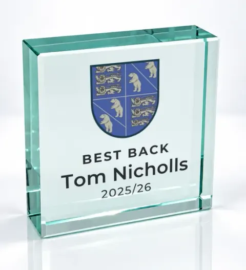 Small square glass award printed with a club crest and the wording Best Back, Tom Nicholls, 2025/26