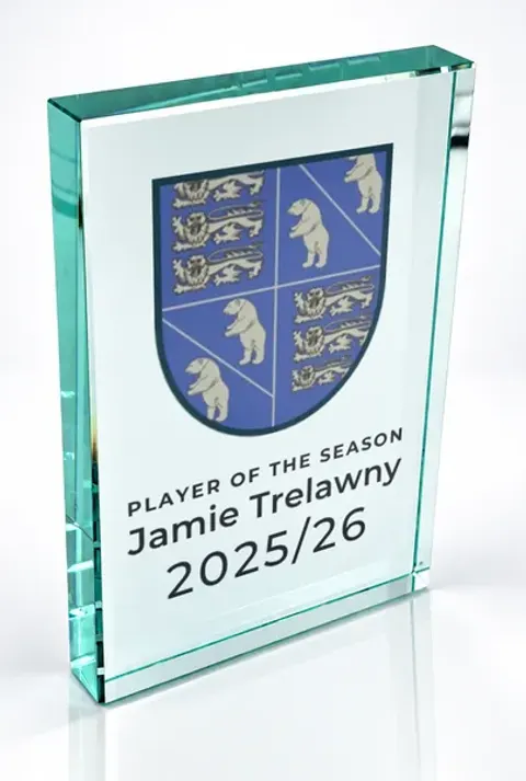 Large portrait glass award printed with a club crest and the wording Player Of The Season, Jamie Trelawny, 2025/26