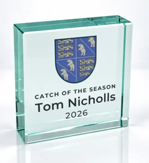 Small square glass award printed with a club crest and the wording Catch Of The Season, Tom Nicholls, 2026