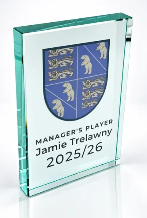 Large portrait glass award printed with a club crest and the wording Manager'S Player, Jamie Trelawny, 2025/26