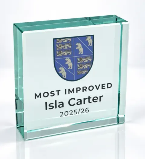 Small square glass award printed with a club crest and the wording Most Improved, Isla Carter, 2025/26