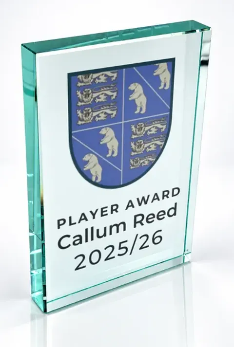 Large portrait glass award printed with a club crest and the wording Player Award, Callum Reed, 2025/26