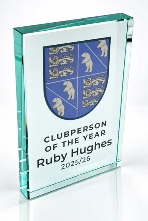 Large portrait glass award printed with a club crest and the wording Clubperson Of The Year, Ruby Hughes, 2025/26