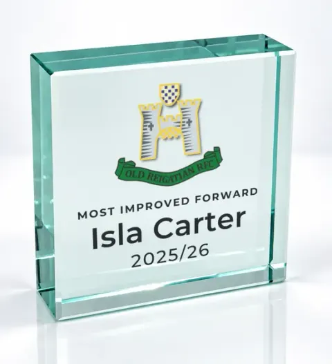 Small square glass award printed with a club crest and the wording Most Improved Forward, Isla Carter, 2025/26