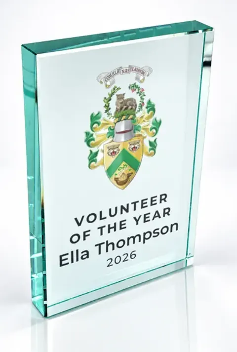 Large portrait glass award printed with a club crest and the wording Volunteer Of The Year, Ella Thompson, 2026