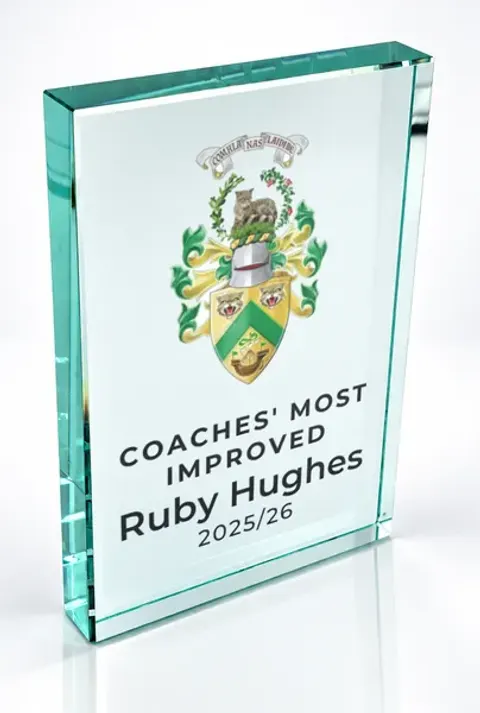 Large portrait glass award printed with a club crest and the wording Coaches' Most Improved, Ruby Hughes, 2025/26