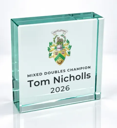 Small square glass award printed with a club crest and the wording Mixed Doubles Champion, Tom Nicholls, 2026