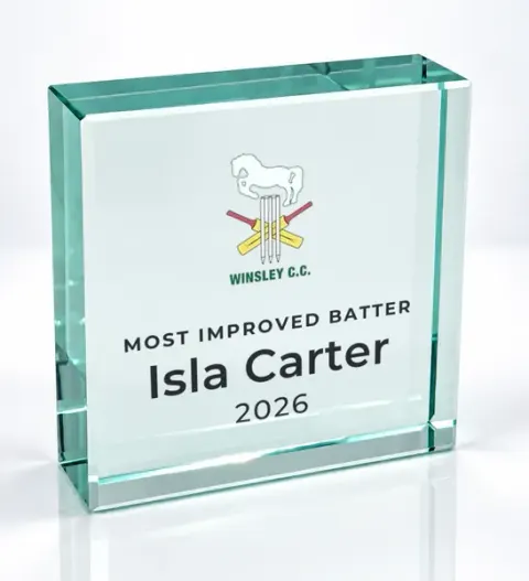 Small square glass award printed with a club crest and the wording Most Improved Batter, Isla Carter, 2026